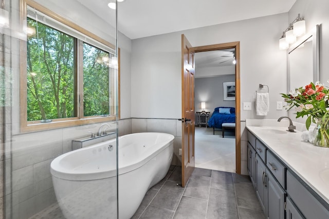13756 Skyline Cir, Louisville Twp, MN 55379 - full bath featuring double vanity, a freestanding tub, ensuite bathroom, ceiling fan, and tile patterned floors