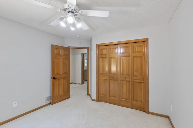 13756 Skyline Cir, Louisville Twp, MN 55379 - unfurnished bedroom featuring light colored carpet, a textured ceiling, a ceiling fan, and a closet