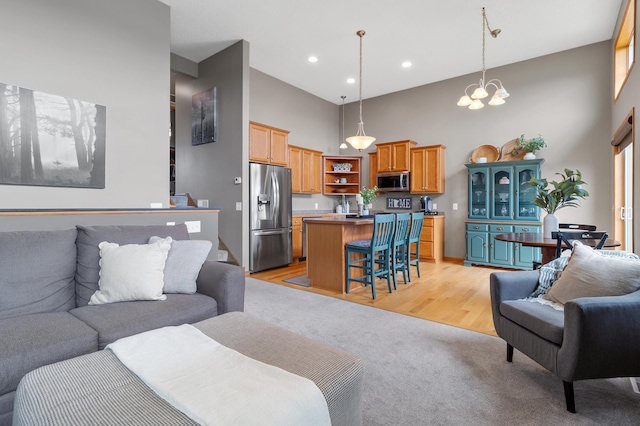 9769 Pinehurst Ct, Elko New Market, MN 55020 - living area featuring a towering ceiling, a chandelier, light carpet, and recessed lighting
