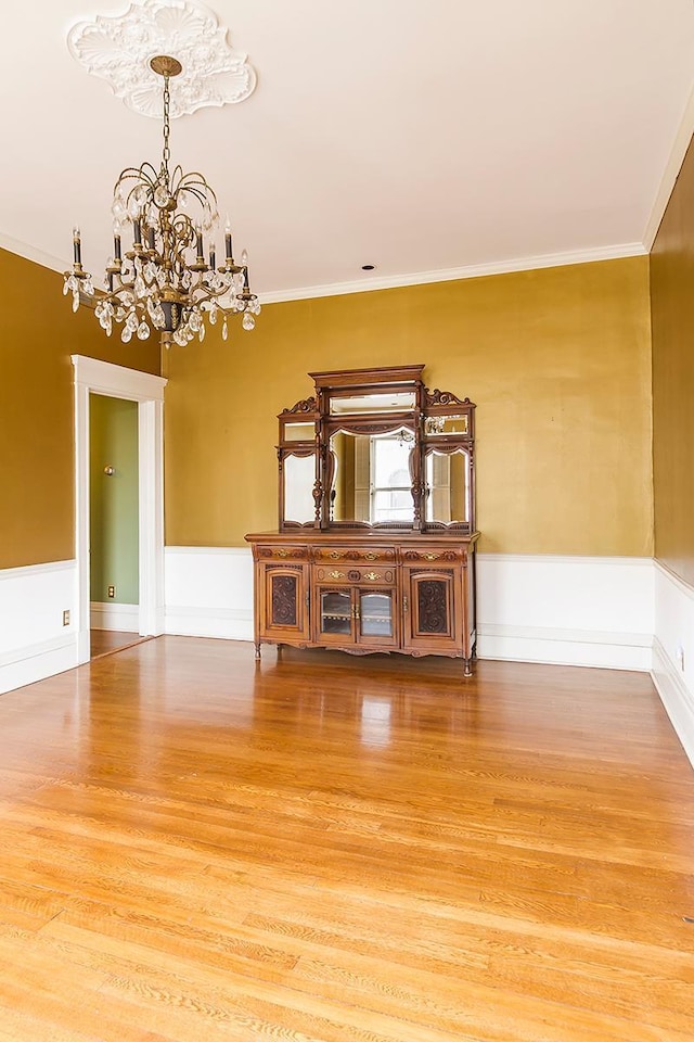 11 Summit Ct Unit 11, Saint Paul, MN 55102 - spare room featuring a chandelier, wood finished floors, and ornamental molding