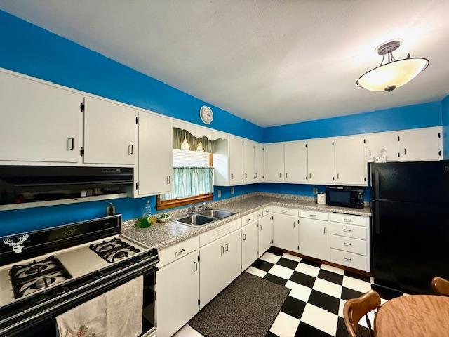 819 Washington St E, Caledonia, MN 55921 - kitchen with black appliances, tile patterned floors, white cabinetry, and light countertops