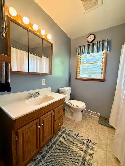 819 Washington St E, Caledonia, MN 55921 - bathroom with lofted ceiling, vanity, and tile patterned flooring