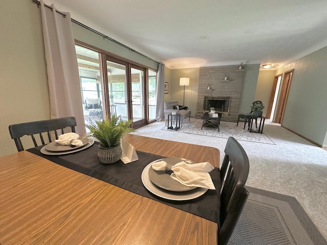 434 Rose Ave E, Saint Paul, MN 55130 - carpeted dining room with a stone fireplace