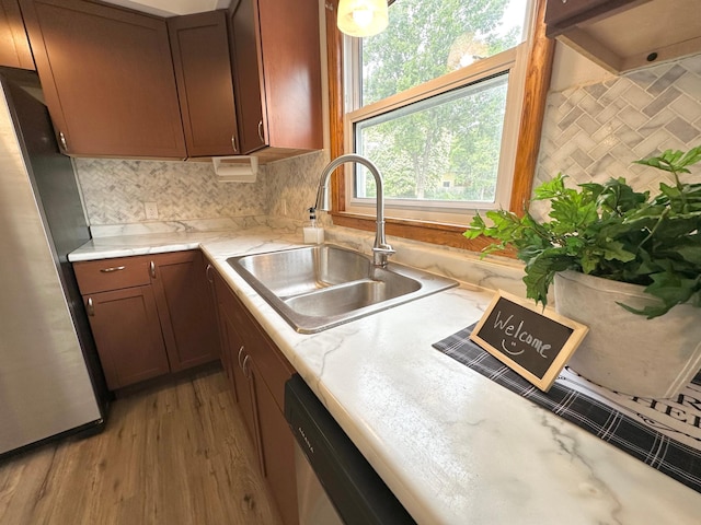 434 Rose Ave E, Saint Paul, MN 55130 - kitchen with freestanding refrigerator, decorative backsplash, and wood finished floors