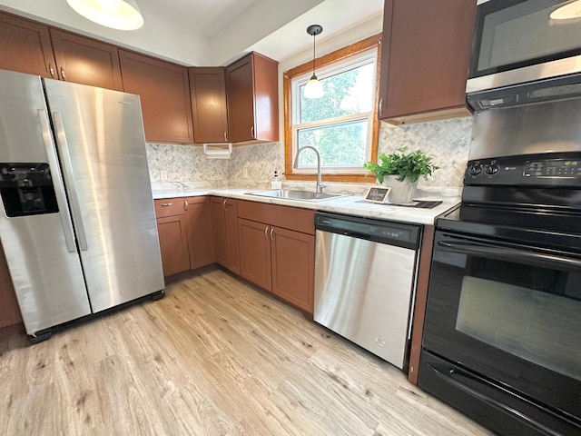 434 Rose Ave E, Saint Paul, MN 55130 - kitchen featuring appliances with stainless steel finishes, light countertops, light wood-style floors, and backsplash