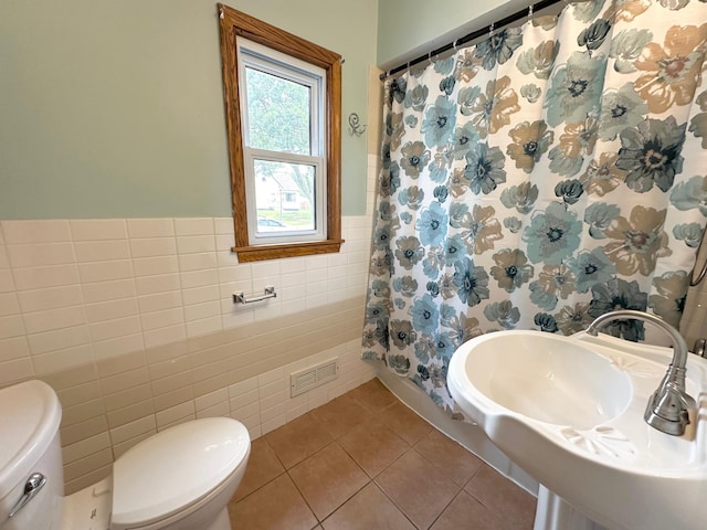 434 Rose Ave E, Saint Paul, MN 55130 - full bathroom with tile walls, tile patterned flooring, wainscoting, and a shower with shower curtain