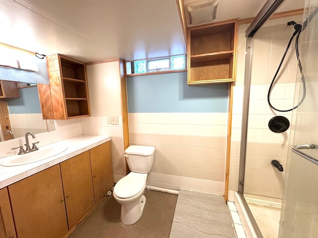 434 Rose Ave E, Saint Paul, MN 55130 - bathroom featuring tiled shower, vanity, wainscoting, tile patterned flooring, and tile walls