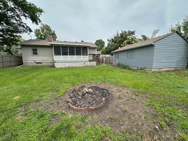 434 Rose Ave E, Saint Paul, MN 55130 - back of house with a fire pit, a sunroom, and a chimney