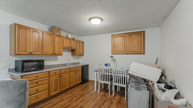 539 Deer Ridge Ln S, Maplewood, MN 55119 - kitchen with black appliances, dark wood finished floors, a textured ceiling, light countertops, and brown cabinets