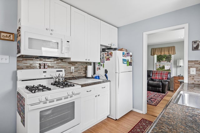 6916 Russell Ave S, Richfield, MN 55423 - kitchen featuring white appliances, light wood-style flooring, backsplash, dark countertops, and white cabinets