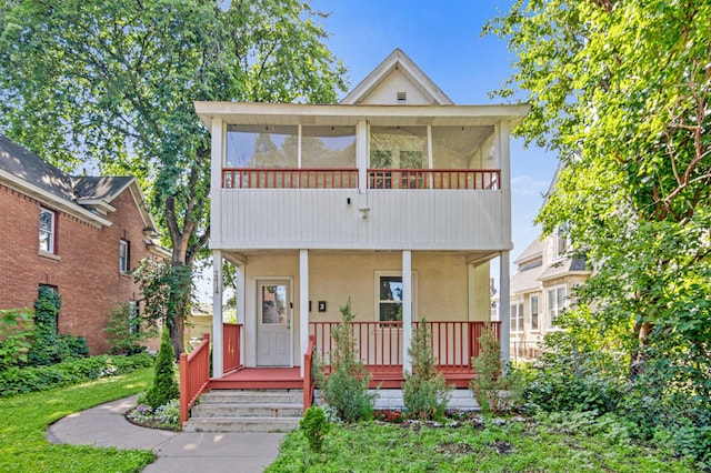 2414 3rd St NE, Minneapolis, MN 55418 - view of front of property with stucco siding, covered porch, a sunroom, and a front lawn