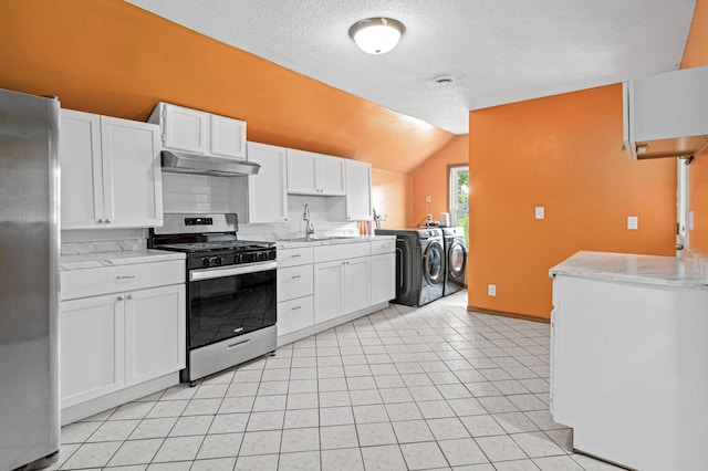 2414 3rd St NE, Minneapolis, MN 55418 - kitchen with washer and clothes dryer, stainless steel appliances, under cabinet range hood, lofted ceiling, and white cabinets