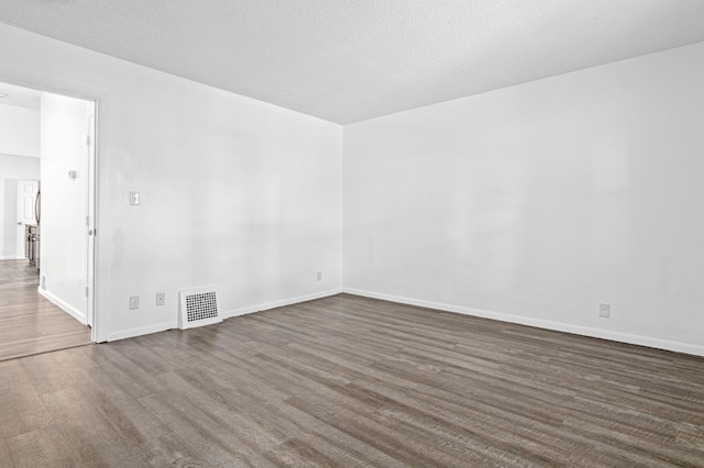 2414 3rd St NE, Minneapolis, MN 55418 - unfurnished room featuring baseboards and dark wood-style flooring