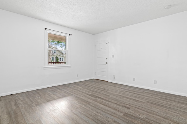 2414 3rd St NE, Minneapolis, MN 55418 - unfurnished room with wood finished floors, a textured ceiling, and a smoke detector