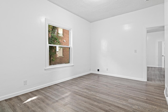 2414 3rd St NE, Minneapolis, MN 55418 - spare room with wood finished floors and a textured ceiling