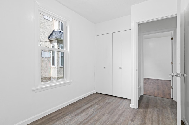 2414 3rd St NE, Minneapolis, MN 55418 - unfurnished bedroom with wood finished floors and a closet