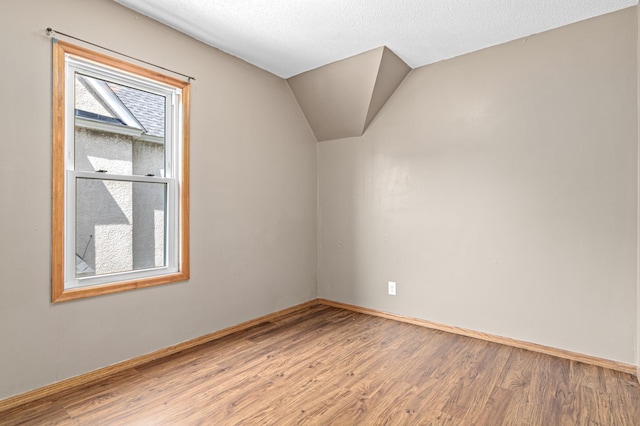 2414 3rd St NE, Minneapolis, MN 55418 - bonus room featuring wood finished floors and vaulted ceiling