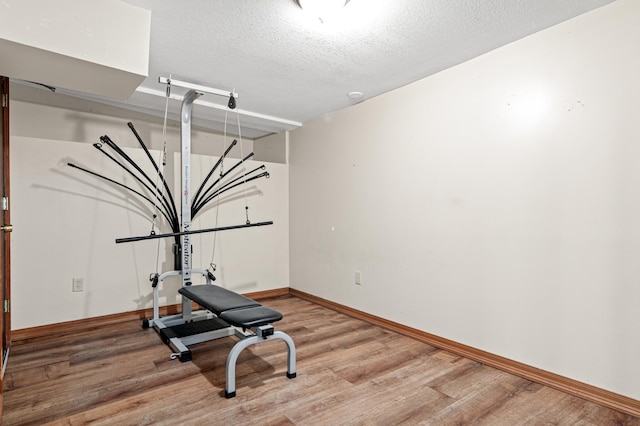 2414 3rd St NE, Minneapolis, MN 55418 - workout area with light wood-type flooring and a textured ceiling