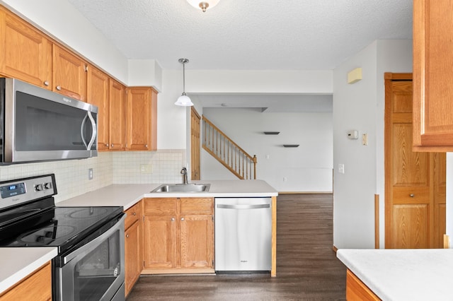 12100 Killdeer St NW Unit 512Nw, Coon Rapids, MN 55448 - kitchen with appliances with stainless steel finishes, dark wood-type flooring, light countertops, a textured ceiling, and backsplash