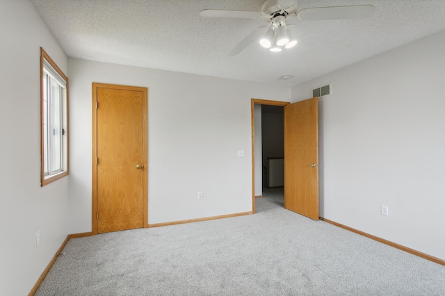 12100 Killdeer St NW Unit 512Nw, Coon Rapids, MN 55448 - unfurnished bedroom featuring carpet, a textured ceiling, and ceiling fan