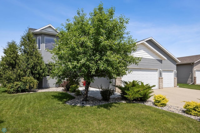 122 15th Ave E, Fargo, ND 58078 - obstructed view of property with driveway, a front lawn, and a garage