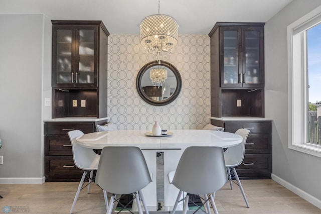 122 15th Ave E, Fargo, ND 58078 - dining area featuring an accent wall, healthy amount of natural light, wallpapered walls, light wood-style floors, and a chandelier