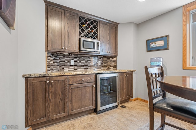 122 15th Ave E, Fargo, ND 58078 - indoor dry bar with wine cooler and tasteful backsplash