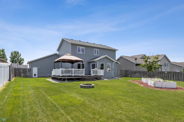 122 15th Ave E, Fargo, ND 58078 - back of property featuring a wooden deck, a gazebo, a fenced backyard, and an outdoor fire pit