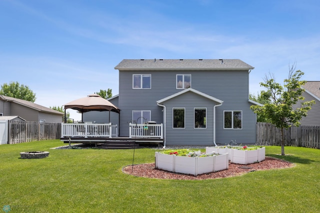 122 15th Ave E, Fargo, ND 58078 - back of property with a gazebo, a wooden deck, an outdoor fire pit, and a fenced backyard