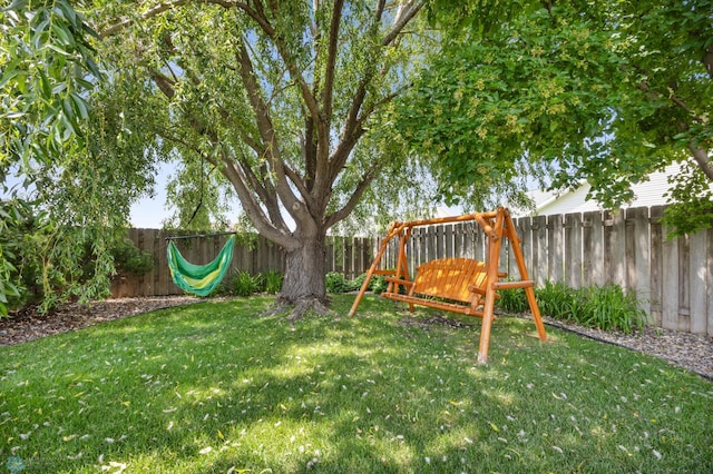 122 15th Ave E, Fargo, ND 58078 - fenced backyard with a playground