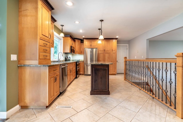 1430 Hoot Lake Dr, Fergus Falls, MN 56537 - kitchen featuring appliances with stainless steel finishes, light stone counters, a kitchen island, recessed lighting, and decorative light fixtures
