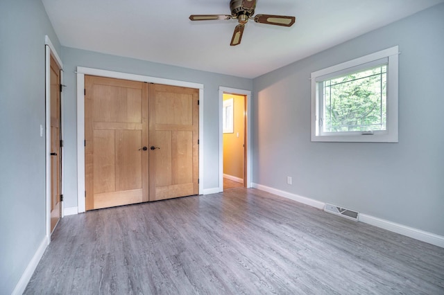 1430 Hoot Lake Dr, Fergus Falls, MN 56537 - unfurnished bedroom featuring wood finished floors, a closet, and a ceiling fan