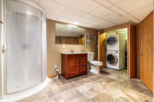 1430 Hoot Lake Dr, Fergus Falls, MN 56537 - bathroom featuring stacked washer and clothes dryer, a paneled ceiling, a shower stall, and vanity