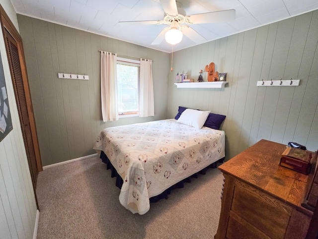 36185 Rose Lake Rd, Hobart Twp, MN 56544 - carpeted bedroom featuring wooden walls, a ceiling fan, and a closet