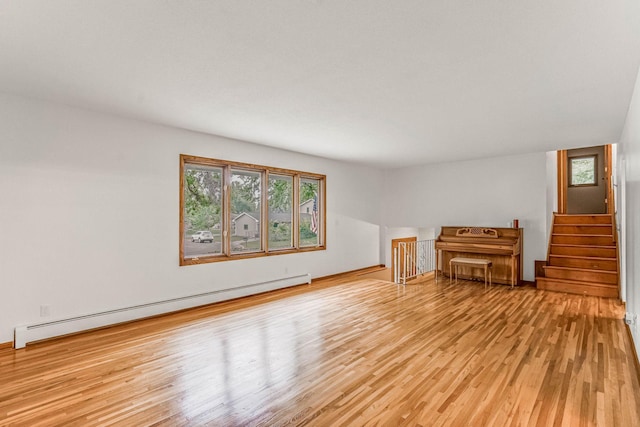 6108 Birchwood Rd, Woodbury, MN 55125 - unfurnished living room with a baseboard radiator, light wood-type flooring, and stairs
