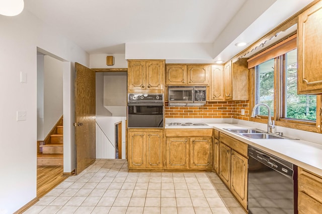 6108 Birchwood Rd, Woodbury, MN 55125 - kitchen featuring black appliances, light countertops, decorative backsplash, light tile patterned floors, and brown cabinets