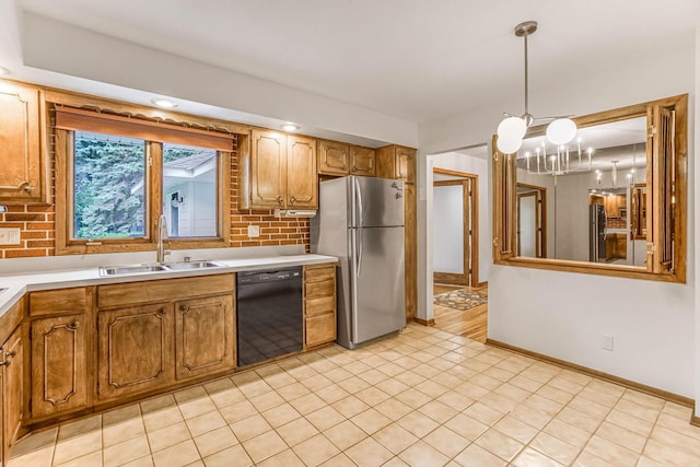 6108 Birchwood Rd, Woodbury, MN 55125 - kitchen with black dishwasher, freestanding refrigerator, light countertops, and a chandelier