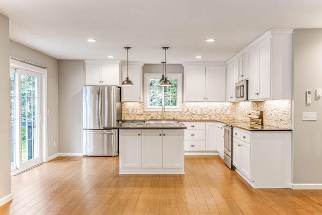 6108 Birchwood Rd, Woodbury, MN 55125 - kitchen with stainless steel appliances, healthy amount of natural light, dark countertops, white cabinets, and recessed lighting