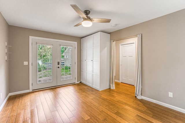 6108 Birchwood Rd, Woodbury, MN 55125 - unfurnished bedroom featuring french doors, access to exterior, light wood finished floors, and a ceiling fan