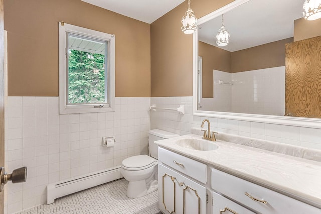 6108 Birchwood Rd, Woodbury, MN 55125 - bathroom featuring baseboard heating, tile walls, vanity, tile patterned floors, and wainscoting