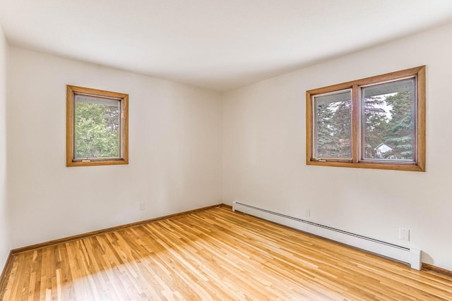 6108 Birchwood Rd, Woodbury, MN 55125 - empty room with baseboard heating and light wood-style floors