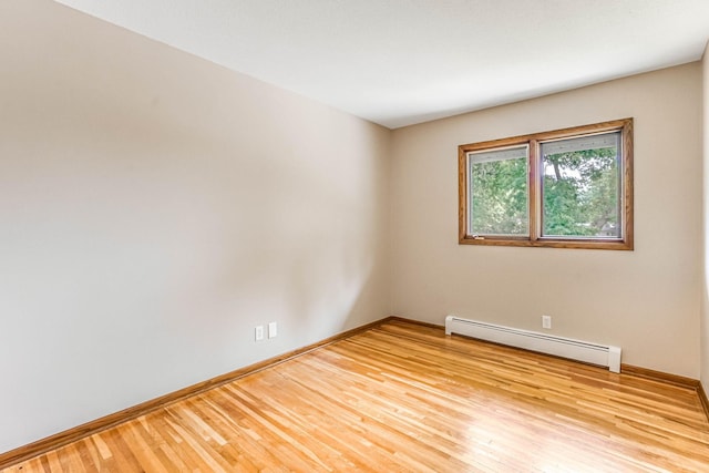 6108 Birchwood Rd, Woodbury, MN 55125 - spare room with baseboard heating and wood finished floors