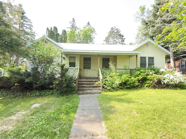 301 Maple St W, Frederic, WI 54837 - view of front of home with covered porch and a front lawn