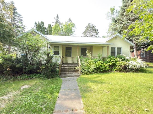 301 Maple St W, Frederic, WI 54837 - view of front facade featuring covered porch and a front yard