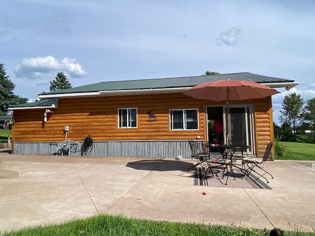 3653 Front St, Barnum, MN 55707 - rear view of property with a patio area, faux log siding, and a metal roof