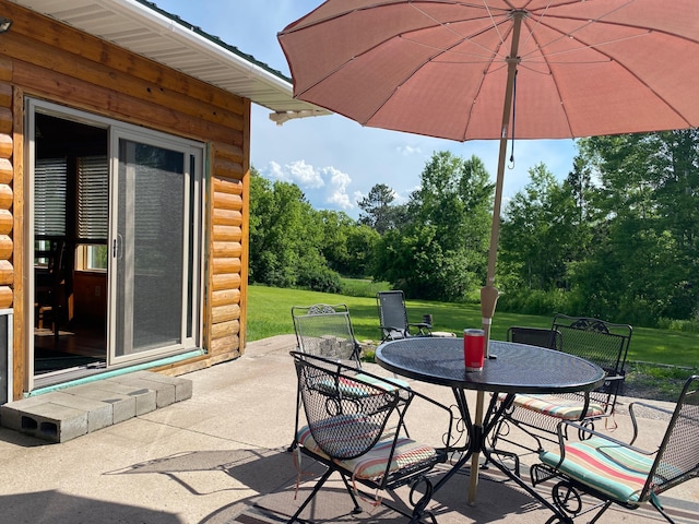3653 Front St, Barnum, MN 55707 - view of patio with outdoor dining area and view of wooded area