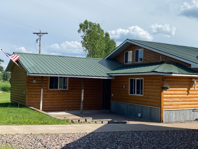 3653 Front St, Barnum, MN 55707 - view of front of property with faux log siding and a metal roof