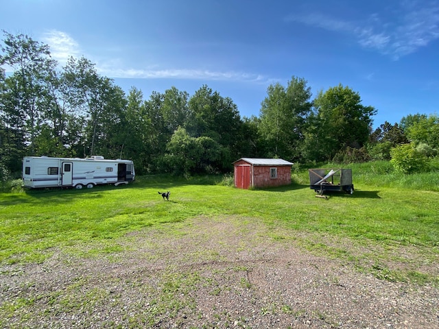 3653 Front St, Barnum, MN 55707 - view of grassy yard with a storage unit