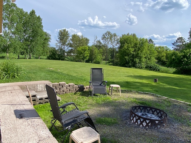 3653 Front St, Barnum, MN 55707 - view of grassy yard with a fire pit and view of wooded area