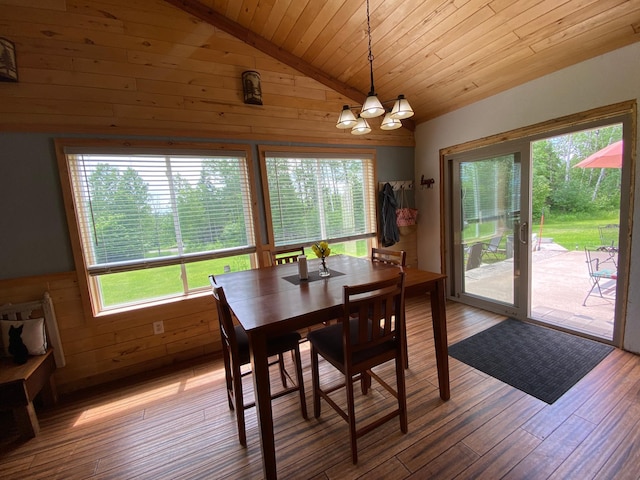 3653 Front St, Barnum, MN 55707 - dining space featuring wooden ceiling, vaulted ceiling, a chandelier, wood walls, and light wood-style floors